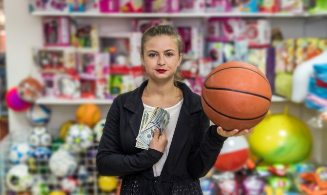 Woman going to buy orange ball for present